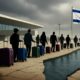Israeli citizens leaving Ben Gurion Airport, symbolizing a mass exodus and the inner collapse of a nation.